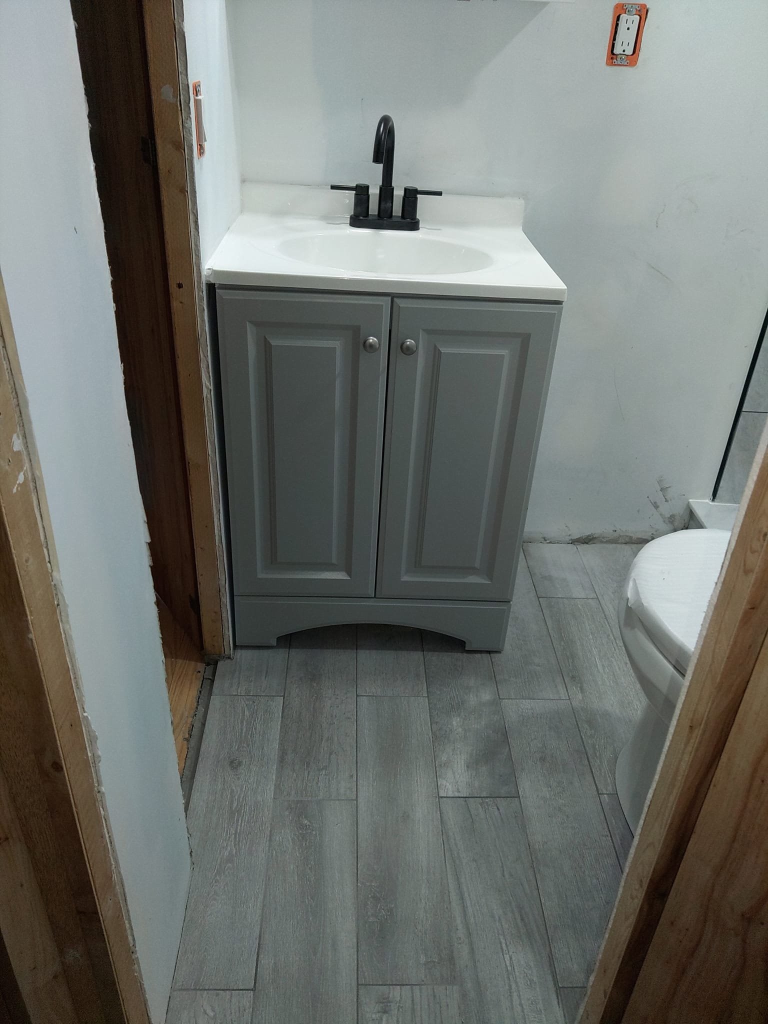 Installed wood-look tile flooring in a bathroom